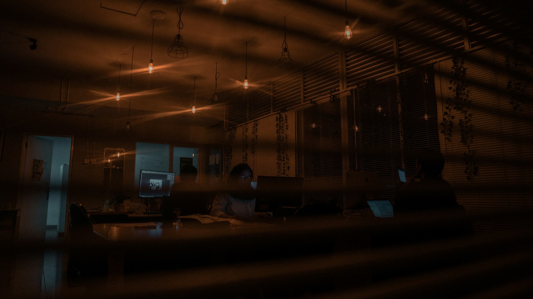 An accountancy office after hours, one desk still lit