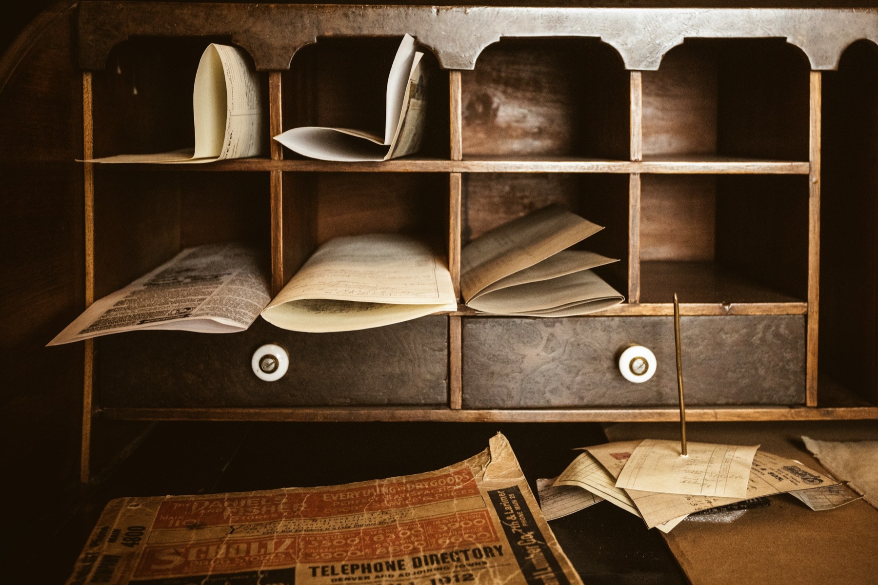 Wooden pigeonholes stuffed with paper